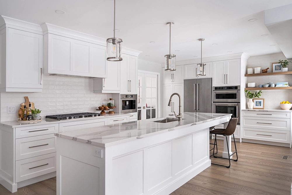 A bright white custom kitchen with a large island