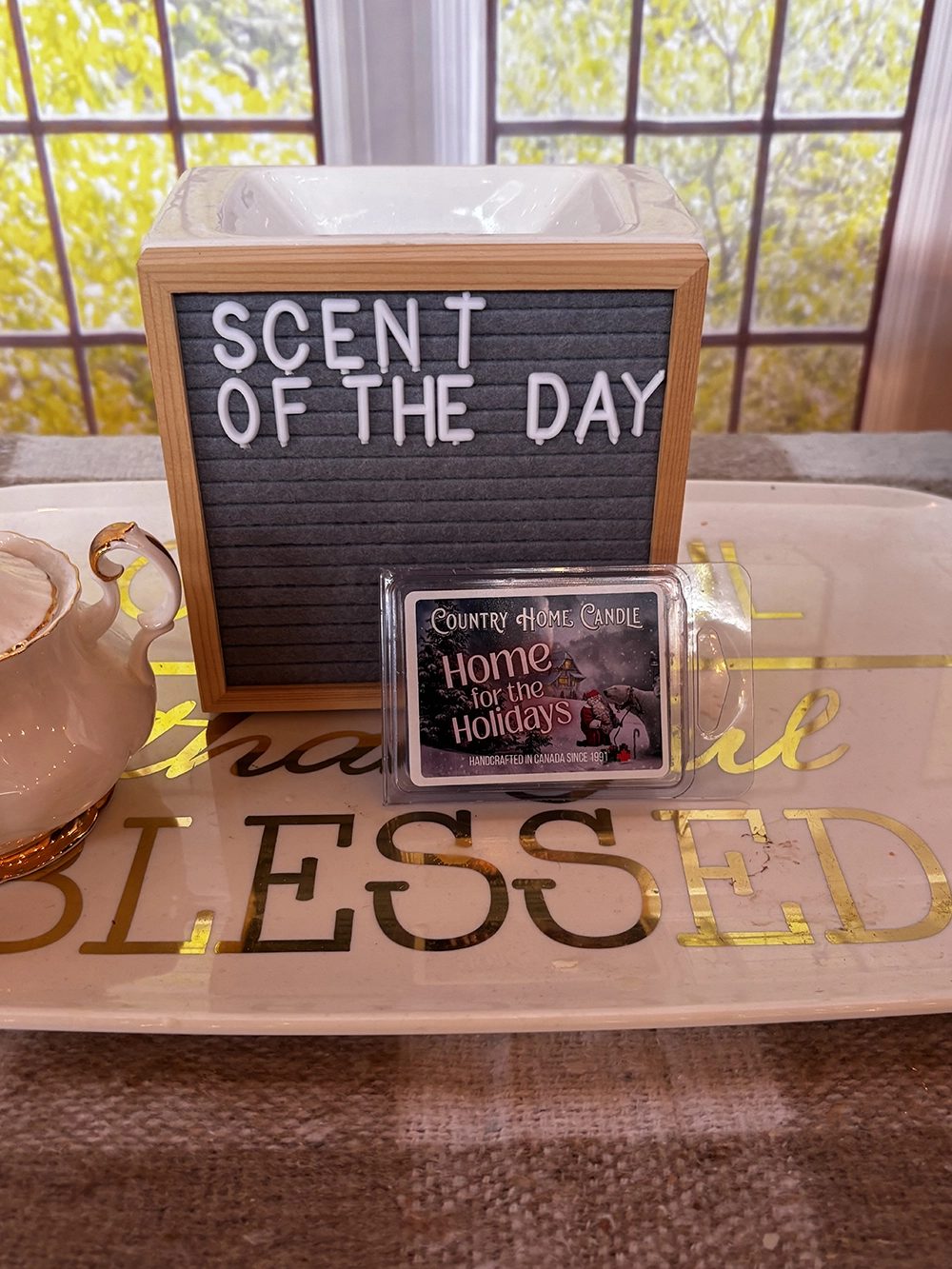 A wax warmer beside the Scent of the Day sign