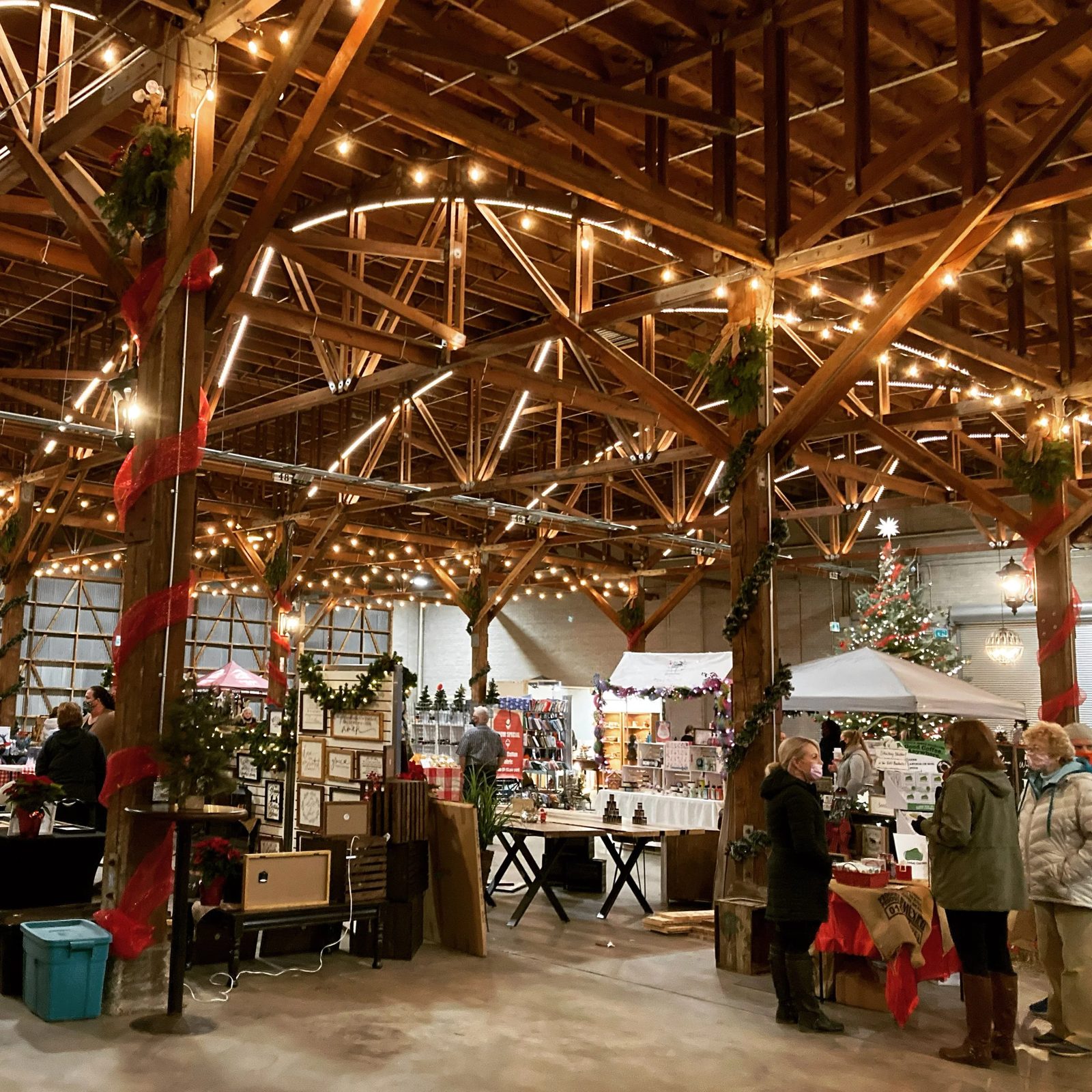 The market floor under timber beams and string lights